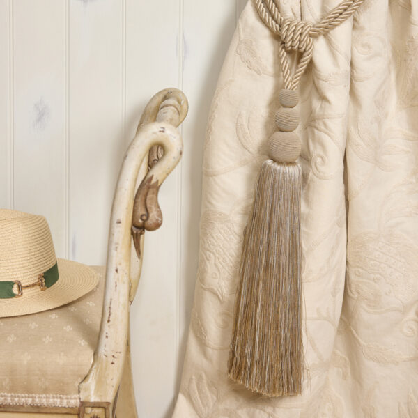 Embroidered fabric curtain with cream tassel